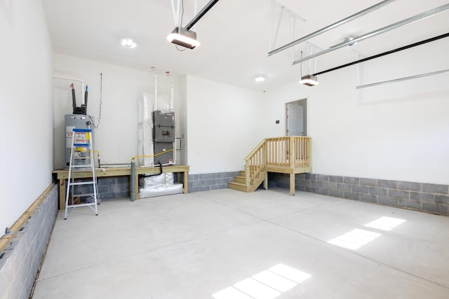 garage with gas water heater, heating unit, and a garage door opener