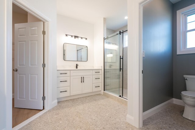 full bathroom featuring a shower stall, toilet, and a healthy amount of sunlight