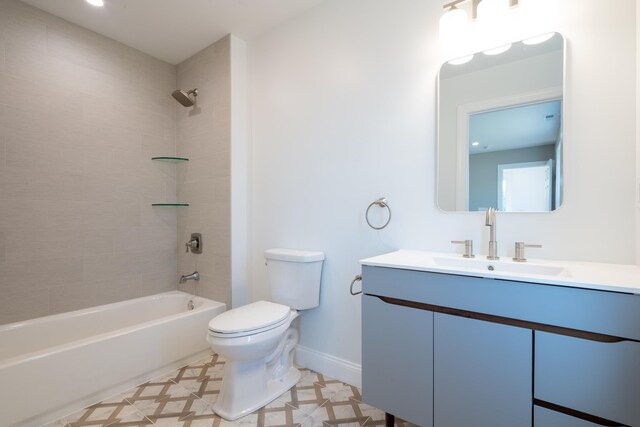 bathroom with toilet, shower / tub combination, baseboards, and vanity