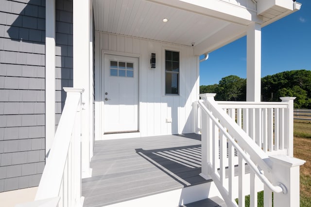 view of exterior entry featuring a wooden deck