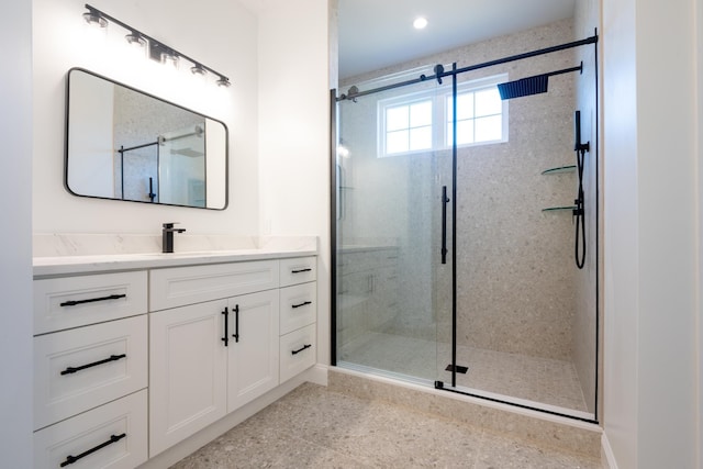 full bath with a stall shower and vanity