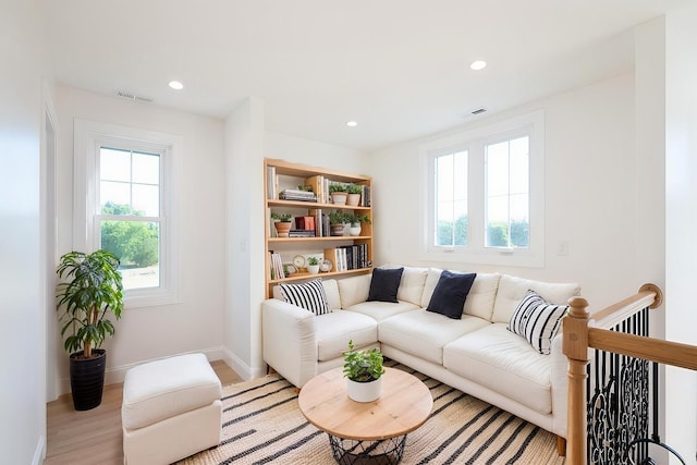 sitting room with recessed lighting, visible vents, and light wood finished floors