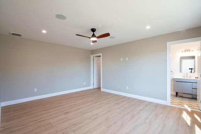 unfurnished room featuring ceiling fan, light wood finished floors, visible vents, and baseboards