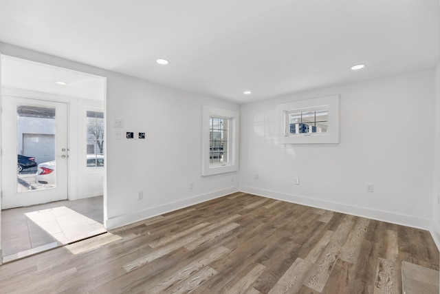 empty room featuring baseboards, recessed lighting, and light wood-style floors