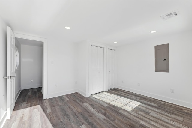 interior space with dark wood-style floors, electric panel, visible vents, and recessed lighting