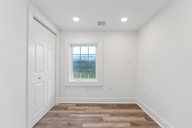 spare room with recessed lighting, baseboards, visible vents, and light wood finished floors