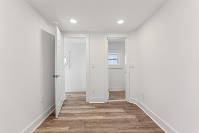 unfurnished bedroom featuring light wood finished floors, recessed lighting, and baseboards