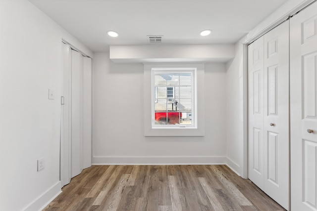 unfurnished bedroom with light wood-style floors, recessed lighting, visible vents, and baseboards