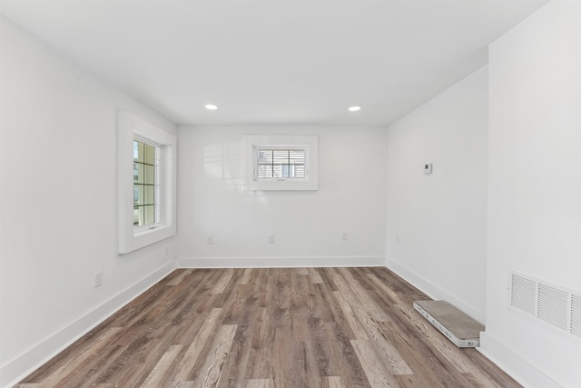 spare room featuring recessed lighting, light wood-type flooring, visible vents, and baseboards