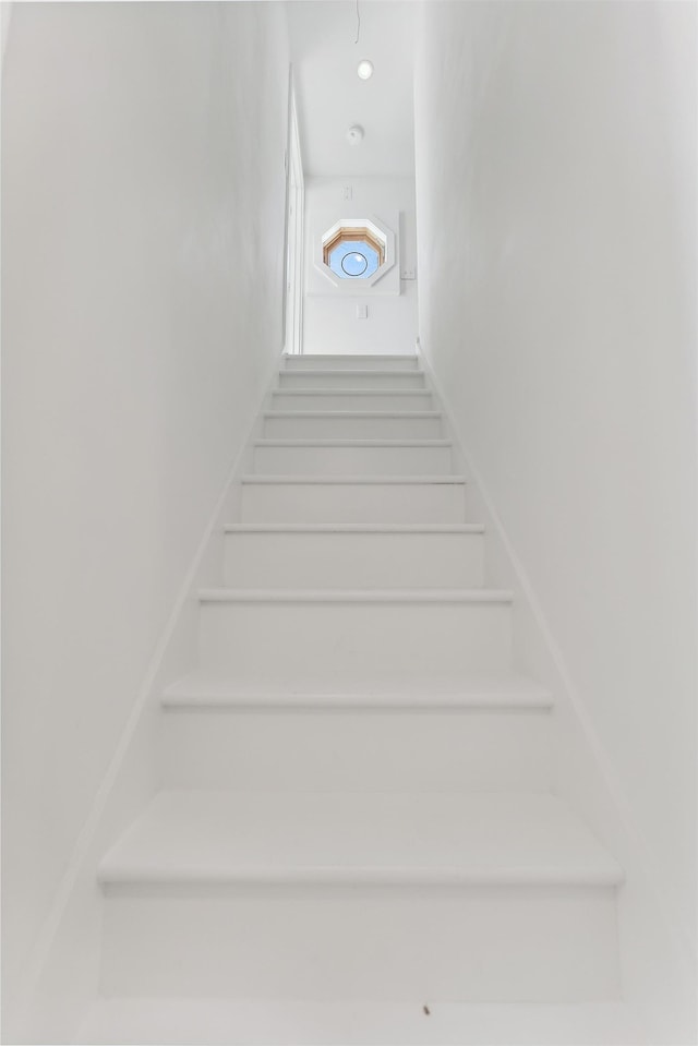 stairs featuring recessed lighting