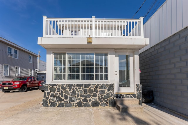 view of exterior entry featuring a balcony