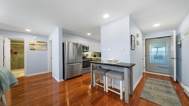 351 96th St Unit 209, Stone Harbor, NJ 08247 - kitchen with appliances with stainless steel finishes, white cabinets, baseboards, dark wood-type flooring, and recessed lighting