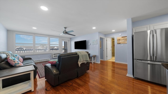 351 96th St Unit 209, Stone Harbor, NJ 08247 - living room featuring a baseboard heating unit, wood finished floors, a ceiling fan, an AC wall unit, and recessed lighting
