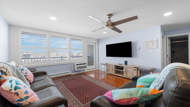 351 96th St Unit 209, Stone Harbor, NJ 08247 - living room featuring a baseboard radiator, wood finished floors, recessed lighting, ceiling fan, and a wall unit AC
