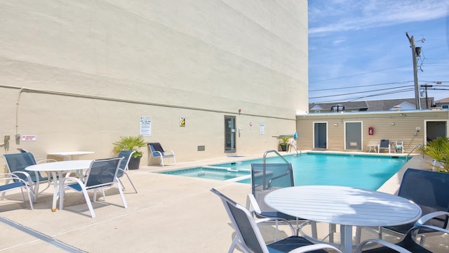 351 96th St Unit 209, Stone Harbor, NJ 08247 - view of swimming pool featuring a patio area, a pool with connected hot tub, and outdoor dining space
