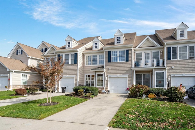 townhome / multi-family property with a balcony and a front yard