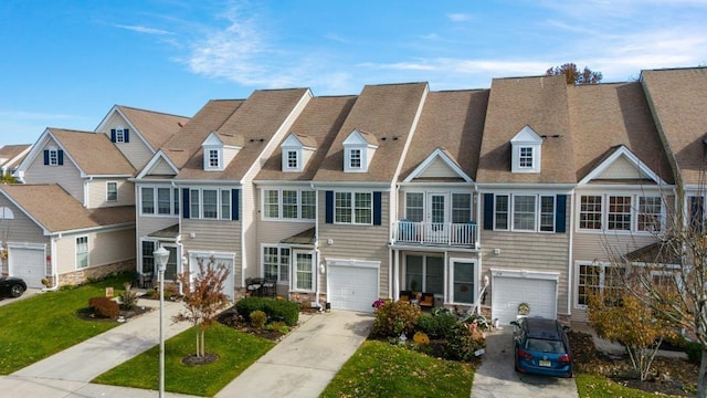 multi unit property with a balcony and a front lawn