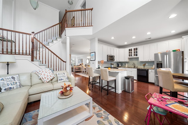 living room with dark hardwood / wood-style floors and sink