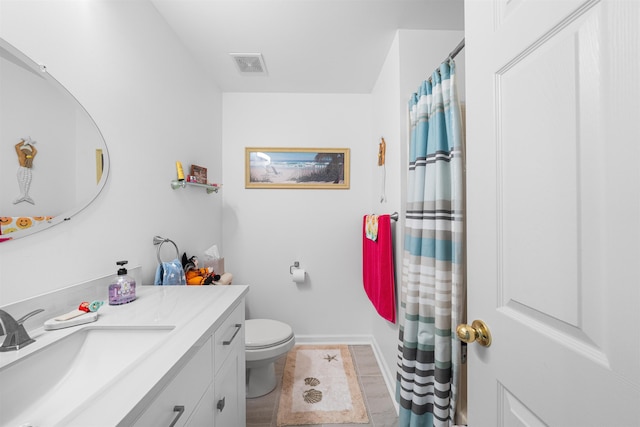 bathroom featuring vanity and toilet