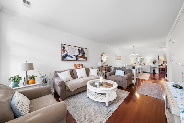 living room featuring dark hardwood / wood-style flooring and crown molding