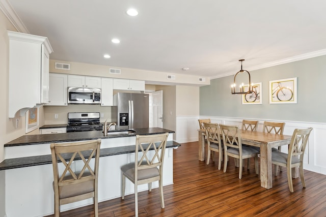 8600 Landis Ave Unit 301, Sea Isle City, NJ 08243 - kitchen with stainless steel appliances, visible vents, an inviting chandelier, and dark countertops
