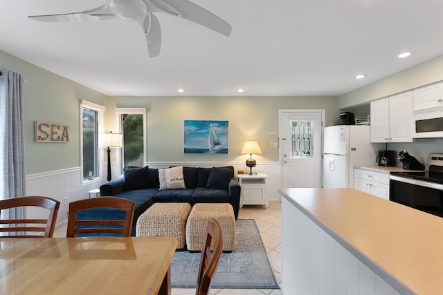 tiled living room with ceiling fan