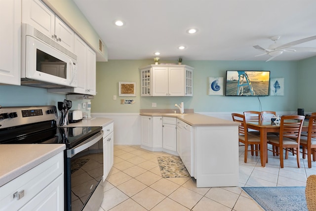 kitchen with white cabinetry, light tile patterned flooring, ceiling fan, and white appliances