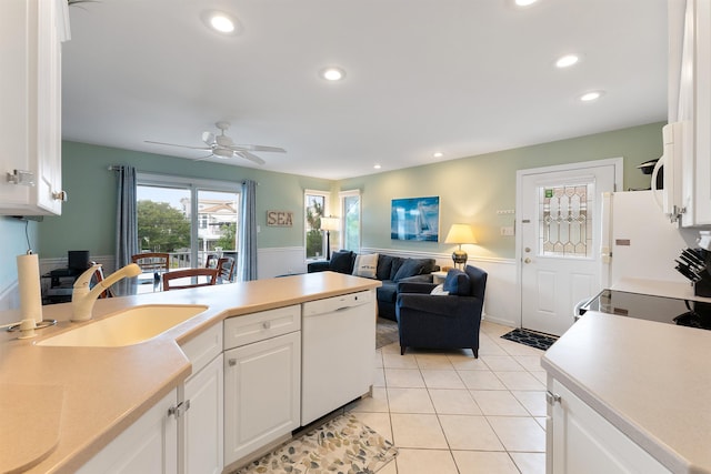 kitchen with white cabinetry, sink, light tile patterned floors, ceiling fan, and white appliances