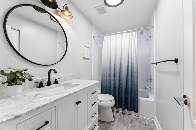 full bathroom with vanity, toilet, hardwood / wood-style floors, and shower / bath combo with shower curtain