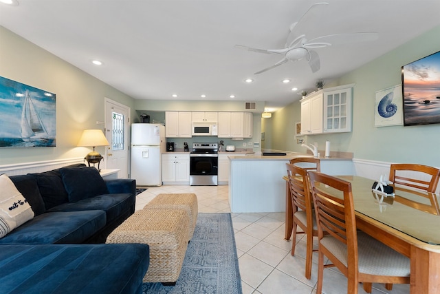 tiled living room with sink and ceiling fan