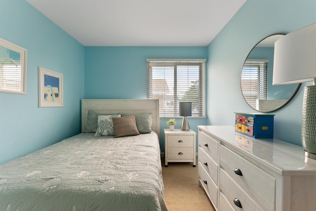 bedroom with multiple windows and carpet