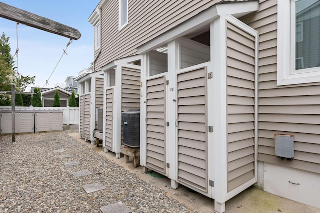 view of side of property with central air condition unit