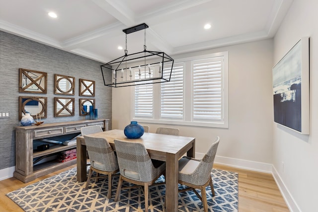 dining room featuring beam ceiling, light hardwood / wood-style flooring, coffered ceiling, and ornamental molding