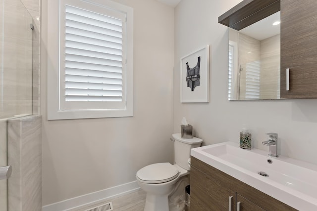 bathroom with vanity, toilet, and walk in shower