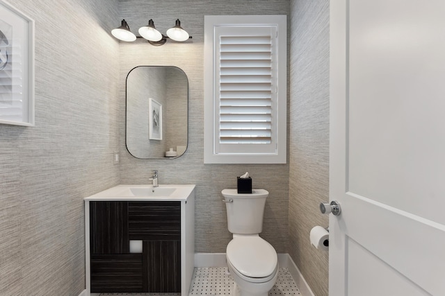 bathroom featuring tile patterned floors, vanity, and toilet