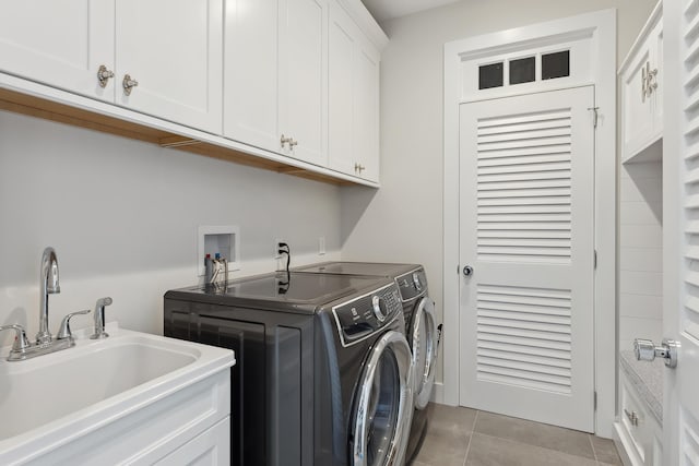 laundry area with cabinets, sink, light tile patterned floors, and washer and dryer