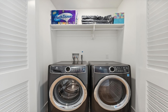 washroom featuring washer and clothes dryer