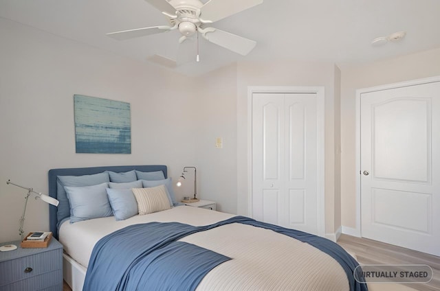 bedroom with a closet, a ceiling fan, and light wood-style floors