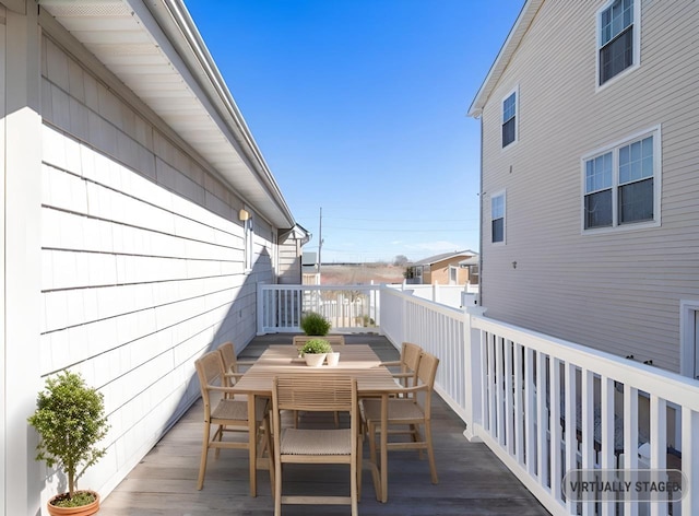 exterior space featuring outdoor dining space and a wooden deck