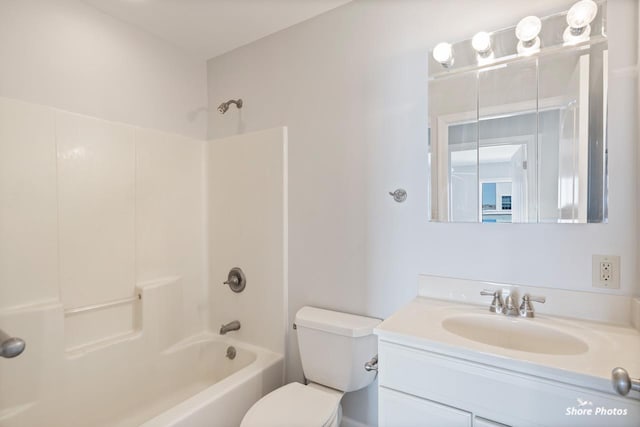 bathroom featuring vanity, bathing tub / shower combination, and toilet