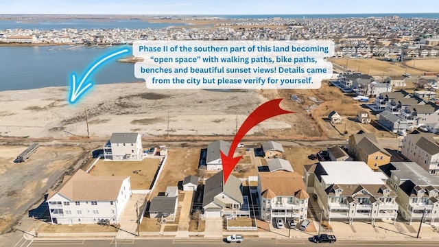 birds eye view of property with a residential view and a water view