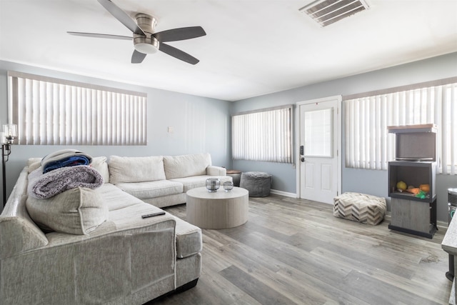 living room with ceiling fan and hardwood / wood-style flooring