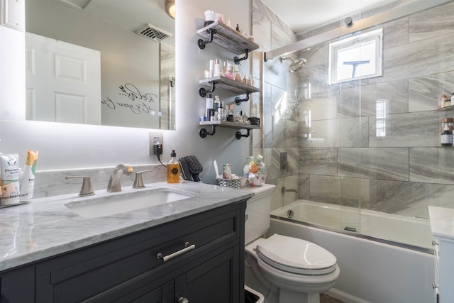 full bathroom with toilet, enclosed tub / shower combo, and vanity