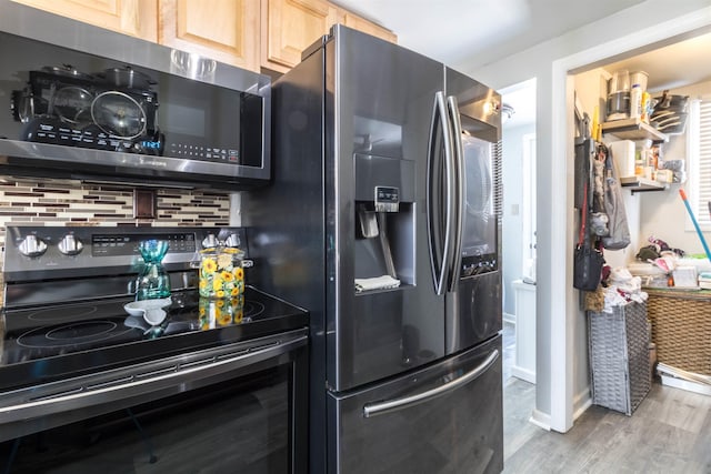 kitchen with stainless steel appliances, light brown cabinets, wood-type flooring, and backsplash