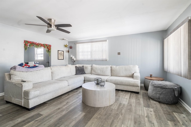 living room featuring ceiling fan and wood-type flooring