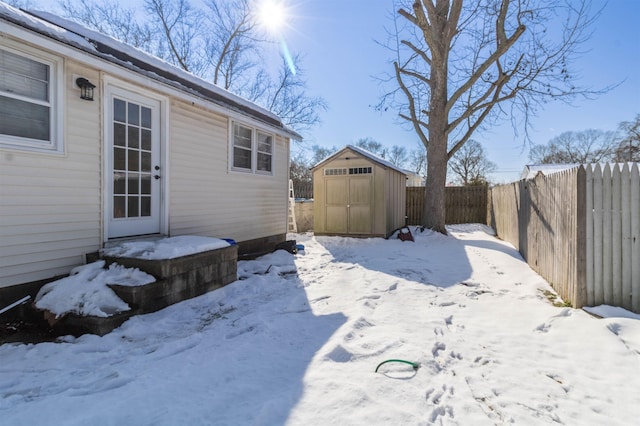 snowy yard with a storage unit