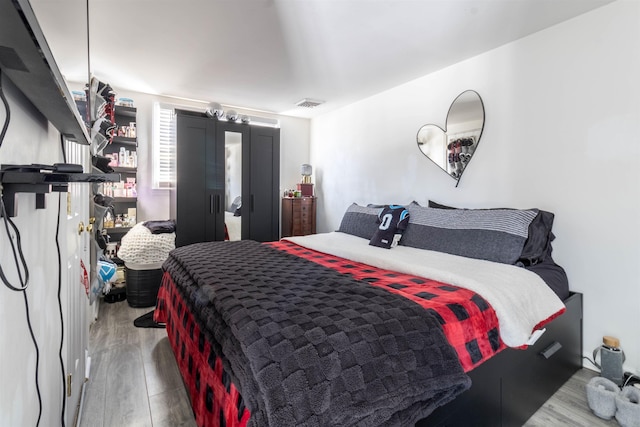 bedroom with hardwood / wood-style floors