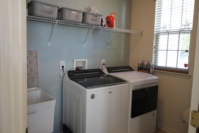 washroom featuring washer and dryer, laundry area, and a sink