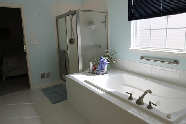 bathroom featuring tile patterned floors, visible vents, a shower stall, and a bath