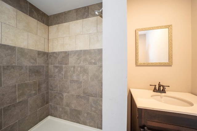bathroom featuring vanity and tiled shower